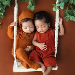 Two tiny humans, side by side on a miniature swing. This image is about remembering not just how little they were, but how close they always were to each other.