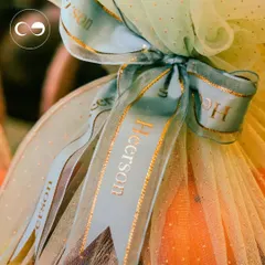 It's all in the details. We created custom-printed ribbons with the family's name in gold foil to wrap these beautiful gift hampers, adding a touch of personalized elegance.
