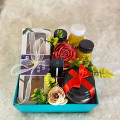 Our "Take Care" hamper is a popular choice for corporate wellness initiatives. This set includes healthy blueberry muffins, immunity-boosting juices, and other comforting items, beautifully arranged with floral accents.