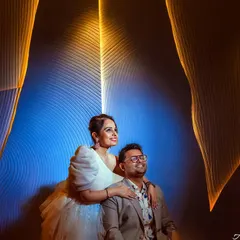 A creative and modern anniversary portrait using light painting. The glowing lines of light create a futuristic and artistic frame around the couple, celebrating their first year together.