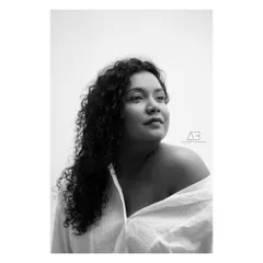 There's a truth that black and white photography reveals. By stripping away color, we get to the core of the person. This portrait is all about her expression and the quiet confidence she exudes.