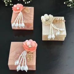 These beautiful resin coin boxes are decorated with delicate flowers and pearl tassels. They are a modern and elegant way to gift shagun, and a lovely keepsake for the recipient.