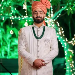A closer look at a cream Lakhnavi sherwani detailed with salli work. The texture of the Lakhnavi fabric combined with the subtle embroidery creates a sophisticated and timeless wedding outfit.