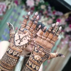 A close-up of the palms from the full bridal set, highlighting the custom initial and the detailed filler work surrounding it.