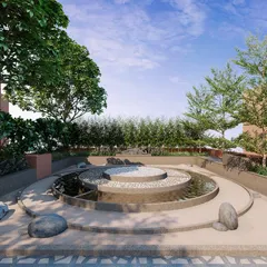 A close-up of the reflexology park, a space designed for therapeutic wellness. The circular water feature and varied textures of stone and pebbles engage the senses and promote relaxation.