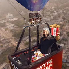 The hero shot from the KFC hot air balloon campaign. Vijay Deverakonda's look is understated, allowing the grand scale of the scene and the "Taste the Epic" branding to take center stage.
