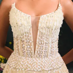 The bodice of the Florence Gown, featuring a deep V-neckline and thousands of tiny, hand-sewn 3D floral embellishments that create a delicate, meadow-like texture.