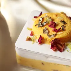 This is my signature Rasmalai Tres Leches tub. It's a fusion dessert that combines the classic Indian sweet with a soft, milky cake, topped with edible gold leaf and rose petals.