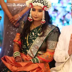 A unique look for an engagement ceremony, featuring a beautiful floral mundavalya. The makeup is kept fresh and glowing to match the celebratory mood.