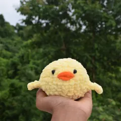 This fluffy yellow chick plushie is the perfect size to sit in your hand. Made with super soft yarn, it's designed to be a cute and effective stress buster for anxious hands.