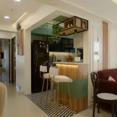 The breakfast bar with stylish high chairs serves as a casual dining spot and a bridge between the kitchen and living room.