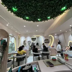 Our team of highly skilled technicians is ready to take care of all your pampering needs. This wide shot shows our team attending to multiple clients in our beautiful studio space.