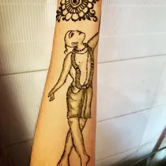 The completed Gaura Hari henna tattoo, shown with the fresh paste. This design is a form of devotional art, perfect for spiritual occasions or as a personal expression of faith.