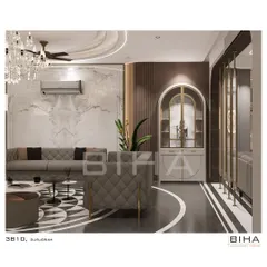 This perspective of the Gurugram living room focuses on the custom arched display cabinet and the intricate metal screen divider. These elements add architectural interest and provide elegant solutions for storage and space definition, enhancing the room's luxurious feel.