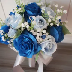 A close-up of a vibrant blue rose bouquet. I used different shades of blue silk roses and delicate white baby's breath to create this striking arrangement, finished with a simple white satin ribbon. It's a great option if you want a pop of color.