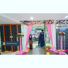 Here’s how we transform a corporate office entrance for a festival. For Radware India, we used bright pink and white fabric drapes, floral pillars, and a traditional flower path to create a welcoming and celebratory atmosphere for employees and visitors.