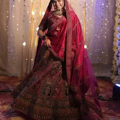 Here is to the bride in all her glory. This classic red bridal lehenga features intricate embroidery and a timeless silhouette, perfect for making your grand entrance on your wedding day.