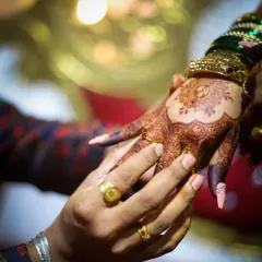 A perfect capture of the bridal henna stain during a wedding ceremony. The deep color on her hands stands out beautifully against the groom's hand.