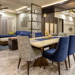 To create a cohesive look between the dining and adjacent family room, we used a rich blue velvet for four dining chairs to match the sofa. The other two chairs feature a patterned fabric, adding a layer of visual interest to the dining set.
