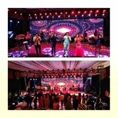 A wide shot of Sachin-Jigar performing for a wedding sangeet. This view captures the entire band on stage and the audience enjoying the show.