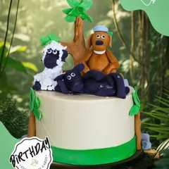 A charming "Shaun the Sheep" cake featuring the whole flock. This fun design brings the playful farmyard antics to life with detailed fondant characters.