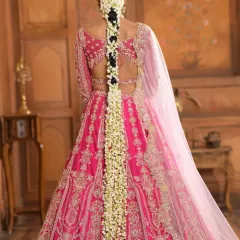 A full-length view of a classic South Indian bridal braid, generously adorned with fragrant jasmine flowers (gajara). This timeless hairstyle is perfect for traditional ceremonies and is designed to look elegant from every angle.
