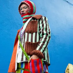 A close-up on the details from the "Kaleidoscope" series. The intricate textures of the knitwear and the bold color palette are the focus here, showcasing the artistry of the garments in this avant-garde fashion shoot.