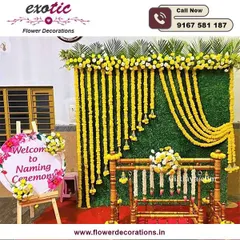 A beautiful setup for a baby's naming ceremony. We created a backdrop of marigold garlands against a green wall, with a traditionally decorated cradle, or 'palna', ready for the baby.