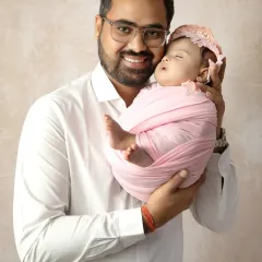 A proud father holding his precious newborn. I love capturing these gentle moments that show the strong, loving connection between a dad and his baby.