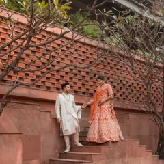 A candid moment captured as the couple descends a grand staircase. The natural interaction and the architectural elements combine to create a photo that feels both grand and personal.