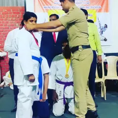 A student receiving his medal. This moment is what we train for.