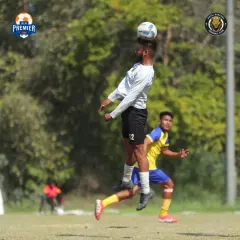 Winning the aerial battle. A player leaps high to win a crucial header, showcasing the physical commitment we bring to every game.