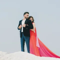 An intimate moment from a pre-wedding shoot, where the couple shares a quiet embrace. The focus is on their connection, with the dramatic red gown adding a touch of cinematic flair.