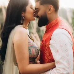 A soft and romantic moment between Rahul and Anjali, about to share a kiss. The natural, backlit setting creates a dreamy and intimate atmosphere.