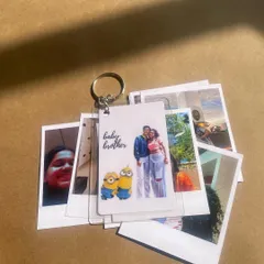 This combo features a custom keychain with a "baby brother" illustration and photo, paired with a set of Polaroid prints. It's a great gift for celebrating family.