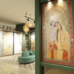 This custom Radha-Krishna tile mural is an example of how we can bring cultural artistry into your home. Set within a modern green-paneled wall, it shows how traditional themes can blend seamlessly with contemporary interior design.