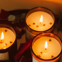 My scented jar candles are perfect for creating a warm and inviting atmosphere. These are shown lit, highlighting the beautiful glow and the special touch of heart-shaped confetti for a romantic theme. You can request different decorative elements to match your occasion.
