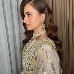This is an example of an elegant and effortless reception look. I focused on creating flawless, glowing skin and soft, romantic waves in her hair to complement her intricate white and gold outfit.