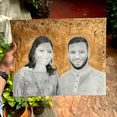 This is a finished custom portrait that combines a realistic graphite drawing with a coffee-painted background and a fine-line floral border. It’s a great way to add warmth to a traditional portrait.
