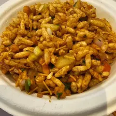 A fresh bowl of bhel puri made to order at our live chaat counter. The mix of puffed rice, sev, onions, and chutneys is a classic street food favorite that everyone enjoys.