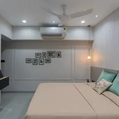 Another angle of the bedroom, focusing on the simple yet elegant TV unit and the beautiful wall molding that adds architectural interest to the space.