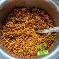 A large batch of Kair pickle being prepared. You can see the green kair berries mixed with grated raw mango and spices. This pickle is a staple in Rajasthani cuisine and has a unique tangy and spicy taste.