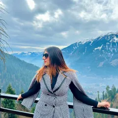 A stunning view of the Manali mountains while wearing a chic houndstooth cape dress from NewMe. This is how I blend high fashion with breathtaking landscapes.