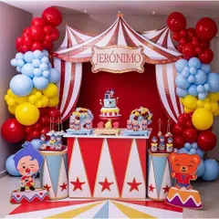 I designed this vibrant, circus themed birthday party for a child's celebration. The setup includes a custom backdrop with red and white stripes, a personalized "Jeronimo" sign, and colorful balloon garlands in red, blue, and yellow to create a fun and festive dessert table.