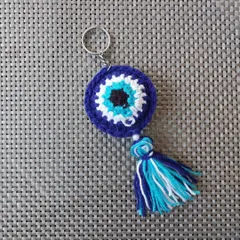 My signature evil eye keychain, handmade with love. This design is a customer favorite for return gifts and corporate freebies, featuring a crochet evil eye, a colorful tassel, and a small pearl for that extra touch.