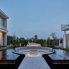 We craft outdoor spaces that serve as tranquil retreats for reflection and connection. This sunken lounge, centered around a fire pit and watched over by a serene Buddha sculpture, is enveloped by a still water body. It is a perfect place to meditate and find balance, transforming the garden into a sanctuary.