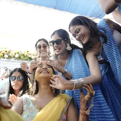 Friends and family are what make a wedding special. Here, my friends are styled in coordinated blue and white leheriya sarees, creating a beautiful contrast against the yellow theme of the Haldi.