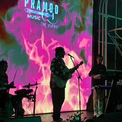 Here is my full band on stage, silhouetted against a dynamic LED backdrop. We use professional lighting and visuals to create a powerful stage presence that elevates the atmosphere of any large pub or event space.