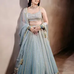 This bride chose an unconventional powder blue lehenga for her Sagan ceremony. The intricate work and fresh color create a look that is both elegant and modern.