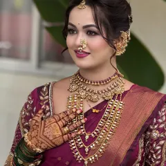 Here you can see the details of the saree drape around the shoulder and chest. I ensure the pallu sits perfectly and the layers of jewelry are displayed beautifully against the rich fabric.